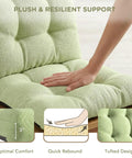 Close-up of sage water-resistant rocking chair cushion showing plush support, tufted design, and hand pressing for comfort.