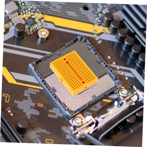 Close-up of a yellow breadboard on a circuit board, showcasing the Plug And Play Solderless Breadboard Kit With Six Compact Yellow Protoboard Panels For Rapid Circuit Assembly And Hassle Free Electronics Crafting For Tech Students And Weekend Builders.