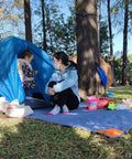 Pocket Picnic Blanket For Grab And Go Outdoor Fun That Folds Small And Lightweight Sandproof 55 By 60 Inch Beach Mat in use at a campsite