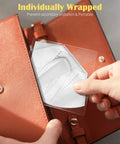 Person placing individually wrapped KN95 Face Mask 5 Ply Disposable Respirator Pack Of 30 For Adults White into orange bag