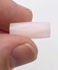 Premium Pink Calcite Faceted Tube Beads 20x10mm Genuine Natural Stone for Jewelry Making, held in hand.