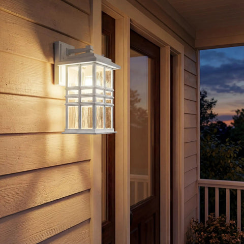 Craftsman Style Outdoor Wall Light In White 12 Inch Tall Exterior Sconce With Clear Hammered Glass glows on porch at dusk