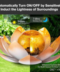Outdoor Garden Solar Lights 2 Pack Amber Crackle Globe Lotus Decorations Waterproof Orange Metal LED Flower Lights For Patio Lawn Walkway Tabletop Ground Totally Lit Garden Gift For Women, amber crackle globe in lotus-shaped light on grass.