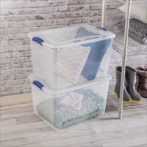 Blue 66 Quart Clear Storage Bin with Latching Lid for Easy Grip Heavy Loads Stackable Plastic Container holding clothes and boots.