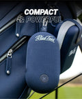 Player Go Golf GPS Speaker With AI Power, blue handheld device attached to golf bag, showing compact design and magnetic strip.