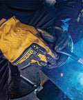 Person welding while wearing Mens 360 Degree Cut Resistant Level 5 Leather Work Glove with Impact Protection in Yellow XL