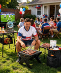 Man grilling at outdoor barbecue with 30000mAh Camping Fan With LED Lantern on a table, party setting, focus on cooling fan.