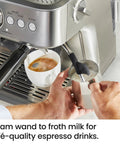 Next Level No Sweat Home Espresso Machine Built Around Conical Burr Grinder Barista Steam Frother frothing milk with steam wand.