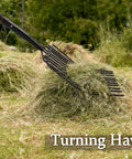 Built Tough Pitch Fork With 10 Tines And Non Slip Handle For Mulching And Garden Cleanup 45 Inch Curved Head Garden Fork in use turning hay