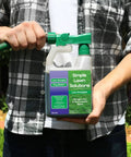 Person holding Heavy Duty Liquid Lawn Fertilizer With Iron And Nitrogen, Hose End Sprayer Included, 32 Ounce container.