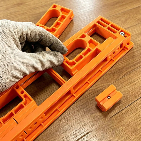 Hand adjusting the durable orange Adjustable Concealed Hinge Router Template For Seamless Cabinet Doors And Reusable Woodworking Guides.