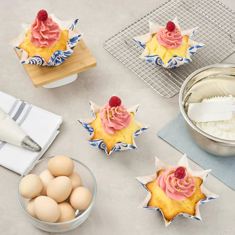 Decorated cupcakes in Bulk 4000 Pack Greaseproof Cupcake Liners 10.2 Ounce Disposable Oven and Freezer Safe Paper Muffin Cups.