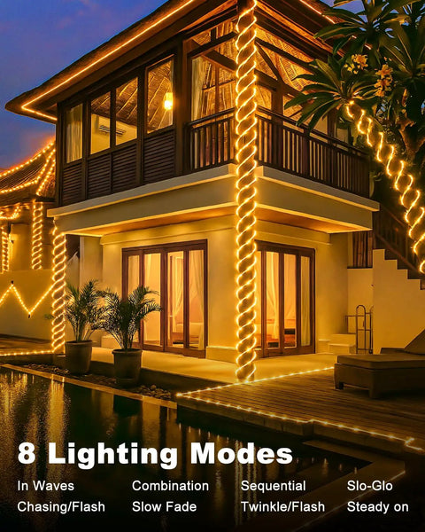 Lit Solar Rope Lights 120LED 46FT Outdoor String Lights Waterproof illuminating a house at night with 8 modes displayed.