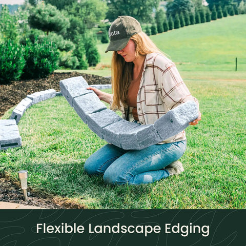 Person installing Landscape Edging Kit With Faux Stone Blocks For Lawn Borders And Flower Beds 10 Pack With 20 Spikes in yard
