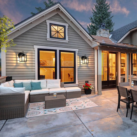 Heavy Duty Outdoor Wall Lanterns Waterproof Exterior Sconces With Beveled Glass on a cozy porch with furniture and potted plants.