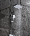 Wall Mount Shower Systems with Rain Shower Handheld and Tub Spout Chrome over sleek stone wall.