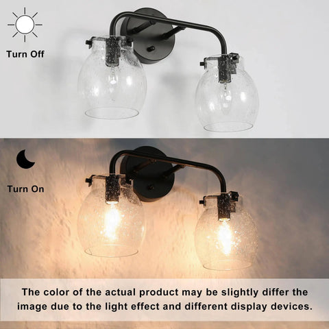 Two light black wall sconce with clear seeded glass globes shown illuminated and off on a white background.