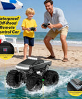 Father and son play with Amphibious 1 to 18 Scale RC Car Beasts All Terrain 4WD Off Road Pickup by the beach.
