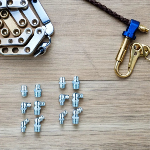Bulk Pack 100 Grease Zerk Fittings, 8 To 28 Threaded Hex Head, 45 Degree Angled Nipples, Galvanized Iron Lubrication Fittings For Mechanical Joints And Machinery, Easy Batch Repairs For Industrial Equipment, assorted angled grease fittings laid out on wood