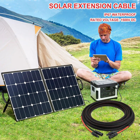Man using tablet outdoors with solar panels and Heavy Duty Twin Wire 50ft Solar Extension Cable, 10AWG in foreground.
