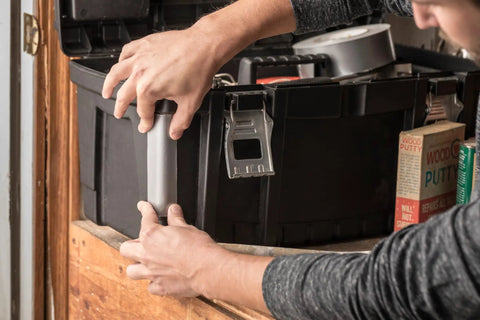 Person using Duct Tape 1.88 Inch By 10 Yard Silver All Purpose Quick Fix Tape For Temporary Repairs on black toolbox.