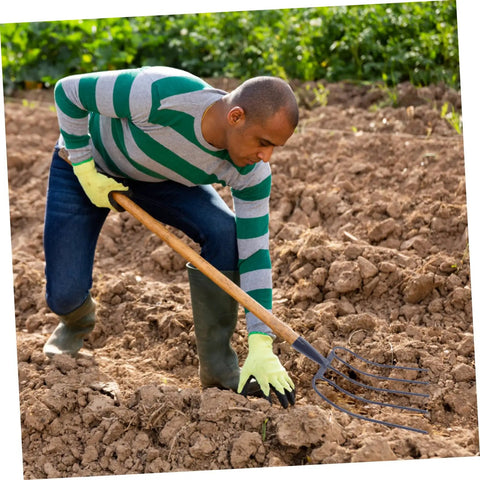 Man using Multi Functional Manure Fork For Mulching And Garden Cleanup No Fuss Heavy Duty Handheld Grass Fork on soil