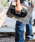 Grab On Pro Electric Suction Cup Lifter holding heavy concrete slab, demonstrating lift aid for pros and dudes at a construction site.