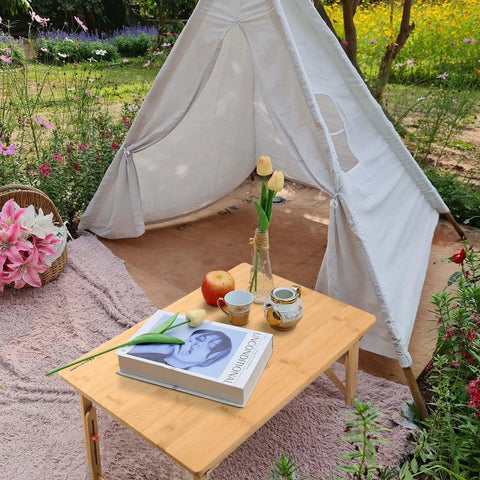 Big Floor Desk Tray With Folding Legs, Adjustable Low Coffee Table with book and tea setup, outdoor garden setting