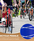 Close-up of navy blue anti-skid aluminum alloy bike pegs insert with cyclists in background.