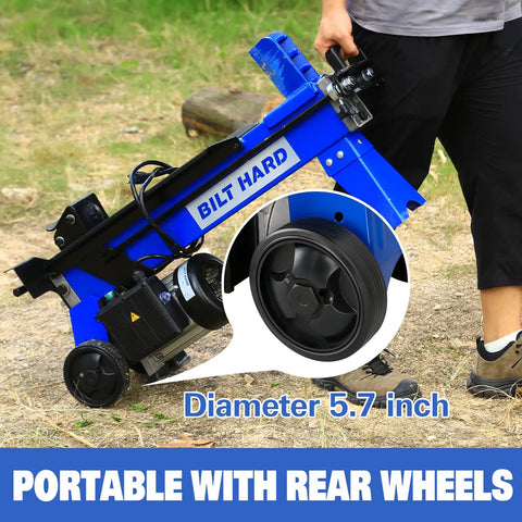 Person transporting a 6.5 Ton Electric Log Splitter With Hydraulic Ram, showing rear wheels for easy mobility.