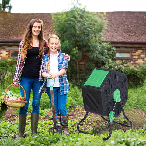 Compost Tumbler Bin With Sliding Doors, 18.5 Gallon Rotating Chamber in garden setting with two people, ideal for kitchen and yard waste.