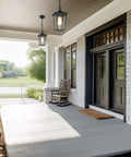 Straight Up Farmhouse Outdoor Pendant Light With Clear Glass Shade And Rust Proof Metal Frame Killing It As A Heavy Duty Hanging Lantern Top Shelf Pick For Porches Entryways And Gazebos In Sleek Matte Black, displayed on porch with rocking chair.