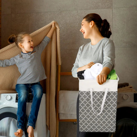 Mother and child doing laundry with Six Pack 75L Large Collapsible Laundry Baskets With Reinforced Handles in gray pattern.