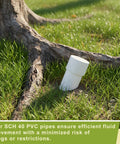 2 Inch PVC Pipes Set Of 6 White Sch40 Industrial PVC Tubes 16.7 Inches Long, one tube near tree roots in grass
