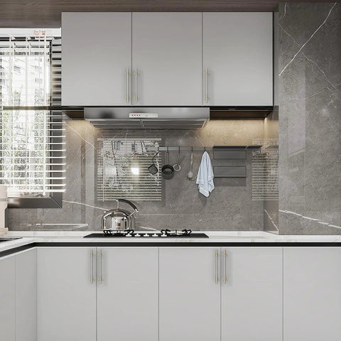 Modern kitchen with Six Pack 5 Inch 128mm Gold and Brushed Satin Nickel Cabinet Pulls on white cabinets, stove, and backsplash.