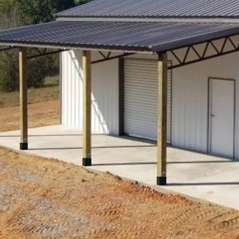 Metal-roofed structure supported by 4x4 wooden posts with black Sturdy 4x4 Post Base Anchor Ground Spike for Concrete Decks and Fence Posts.