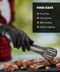 Tough As Nails Black Nitrile Work Gloves 6 Mil Heavy Duty Fully Textured Grip Ideal For Auto Mechanics Shop Jobs And Daily Grind Large 100 Count Box Latex Free Powder Free worn by person grilling meat outdoor.