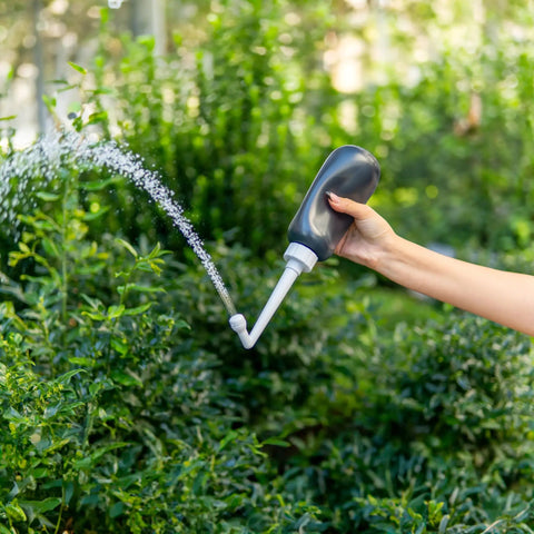 MicroJet MJ 450 Portable Bidet And Peri Bottle Sprayer For Travel demonstrating precise water jet outdoors