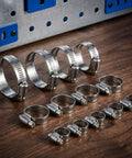 30Pcs 304 Stainless Steel Hose Clamps Set with 6-51mm adjustable, interlocking design, displayed in five size groups on a table.