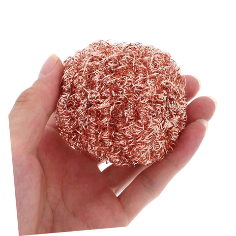 Hand holding a copper wire sponge ball, part of Six Pack Soldering Tip Copper Wire Sponge Balls For Efficient Tin Removal And Clean Tip.
