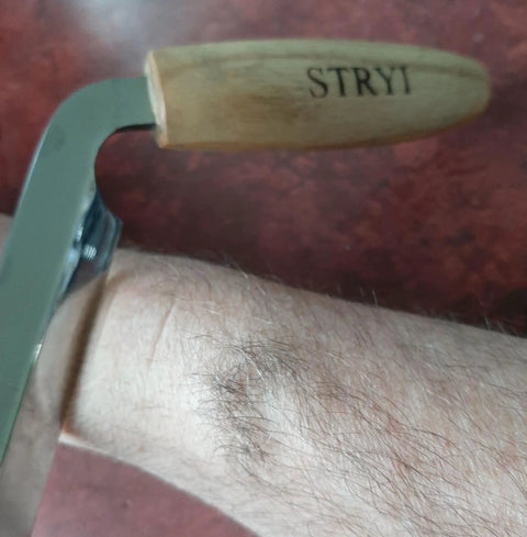 Pro Grade Dual Handle Draw Knife Sporting A Killer Razor Edge And Sweet Grip with oak handle shown on a hand.