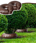 8 Pack 15 Gallon Tree Watering Bags With Slow Release Rings surrounding shrubs in garden, brown PVC drip irrigation pouches.