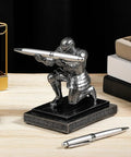 Knight Pen Holder With Two Pens And Resin Desk Organizer For Men placed on wooden desk near books and sunglasses.