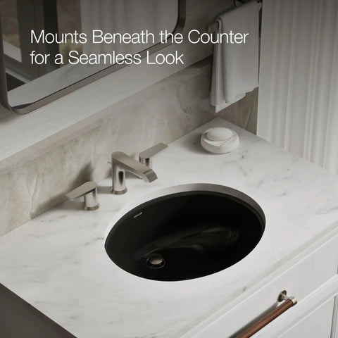 Caxton Oval Undermount Bathroom Sink with sleek easy-to-clean design shown beneath a marble countertop in modern bathroom setting