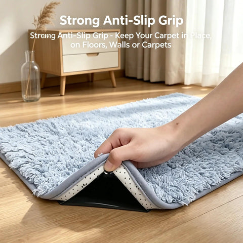 Eight Piece Triangle Rug Pads Set 70x70mm No Slip Dual Sided Adhesive Pads For Hardwood Floors Tiles Marble Reusable Rug Tape Keeps Area Rugs Flat And Prevents Curling Black in use under a blue rug on hardwood floor.