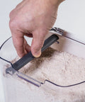 Hand using Flour Storage Canister 4 Quart Airtight Container With Silicone Seal And Stainless Steel Hinges, BPA Free Plastic