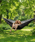 Portable Double Camping Hammock With Tree Straps And Carry Bag 600Lb Nylon Outdoor Lounge For Travel Hiking Beach Backyard Or Indoor Use Ultra Comfy Parachute Nylon Construction Quick Drying For All Season Comfort in use outdoors