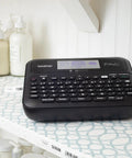 Pro Grade P-Touch PT-D610BTVP Connected Label Maker For Business And Retail on shelf next to labeled bottles