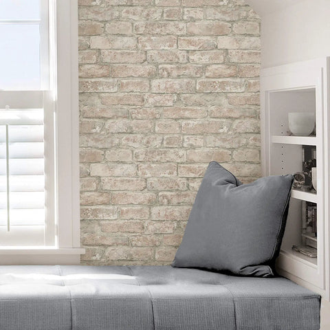 Denver Brick White Washed Peel And Stick Wallpaper Removable Contact Paper For Walls in cozy room with cushion and shelves.