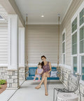 Bulletproof Heavy Duty Swing Hangers 4 Pack supporting a woman and child on a porch swing in a residential setting.